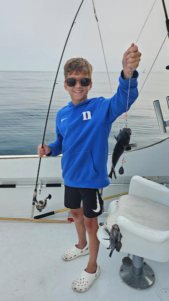 boy with black sea bass on the sinbad