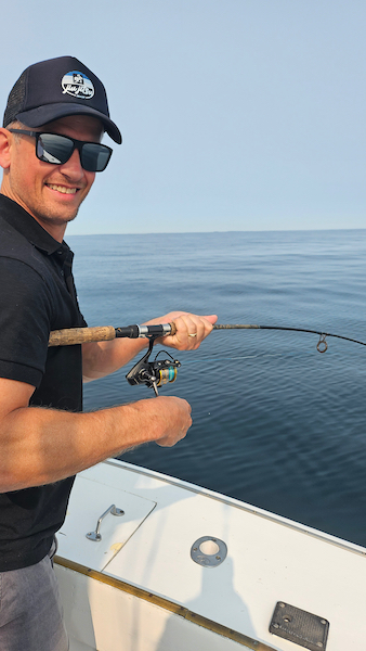 bottom fishing aboard the sinbad man with small rod bent double